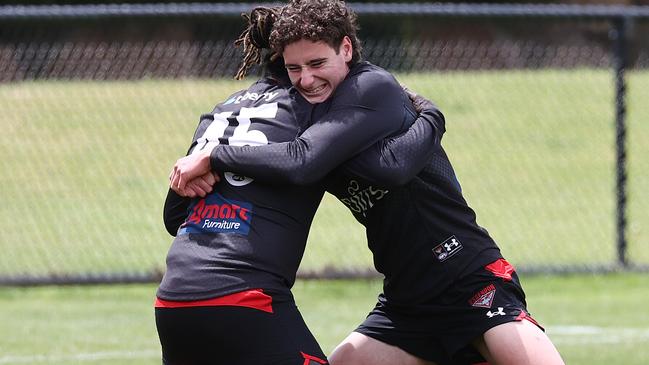 MELBOURNE . 14/12/2022.  AFL. Essendon training at the Hangar, Tullamarine.   Elijah Tsatas wrestles with Anthony McDonald-Tipungwuti during todays session   . Picture by Michael Klein