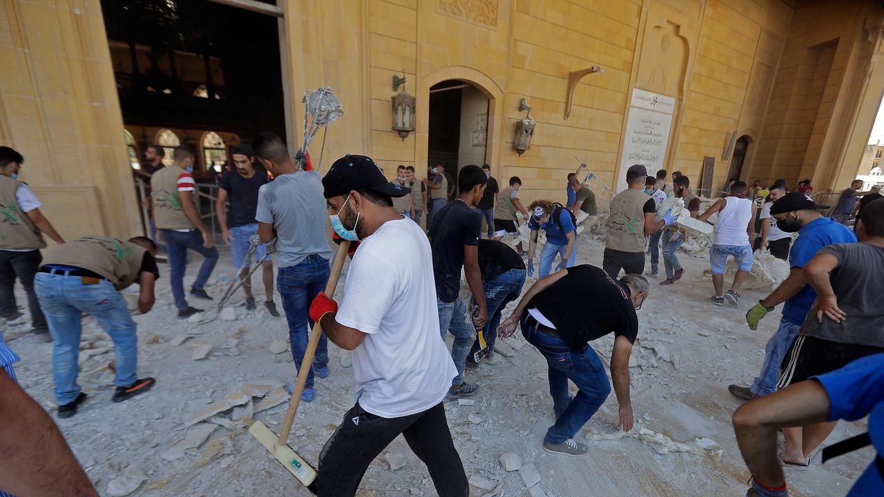 People clean debris at Mohammed al-Amin mosque in the centre of Beirut. Picture: AFP