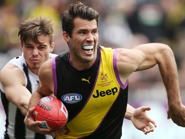 AFL Round 19. 28/07/2018. Richmond v Collingwood at the MCG.  Richmond's Alex Rance charges through the tackle of Collingwood's Josh Thomas  .Pic: Michael Klein