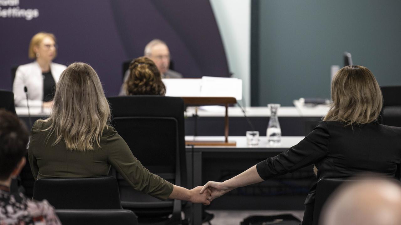 Two members of the public listening to the inquiry hold hands during Marcia Neave's opening address. Commission of Inquiry into the Tasmanian Government's Responses to Child Sexual Abuse in Institutional Settings held in Hobart. Picture: ABC