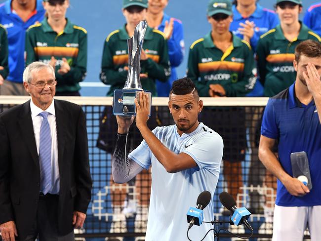 Nick Kyrgios of Australia holds the winners trophy after defeating Ryan Harrison