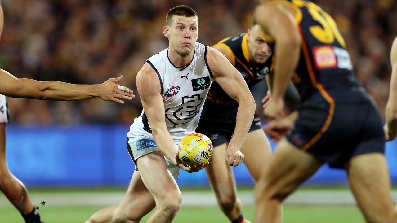 Sam Walsh shoots out a handball. Picture: Sarah Reed/AFL Photos via Getty Images