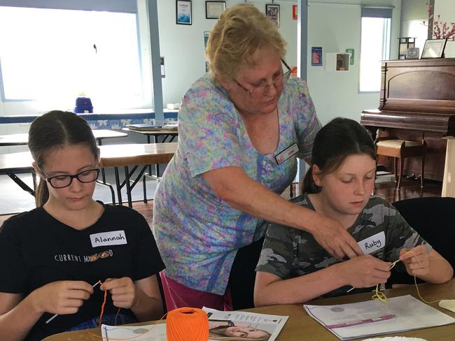 Allannah Redo and Ruby Crowther getting some help with their crochet techniques from Anne Gentle. Picture: Contributed