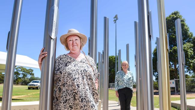 SA Women’s Memorial Playing Fields Trust president Helen Fischer and Vice President April Williams among 22 poles erected as a memorial to the nurses massacred on Bangka Island in Indonesia in 1942. Picture: Brenton Edwards