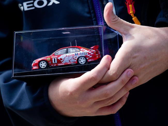 Brad O'Connor holds a model of a Mark Skaife racer. Picture: Mark Stewart