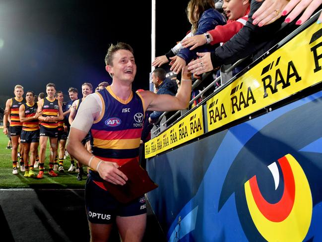 Matt Crouch of the Crows leads his team off the field following his 100th game in the Crows 33-point win over Richmond at Adelaide Oval. Picture: AAP Image/Sam Wundke