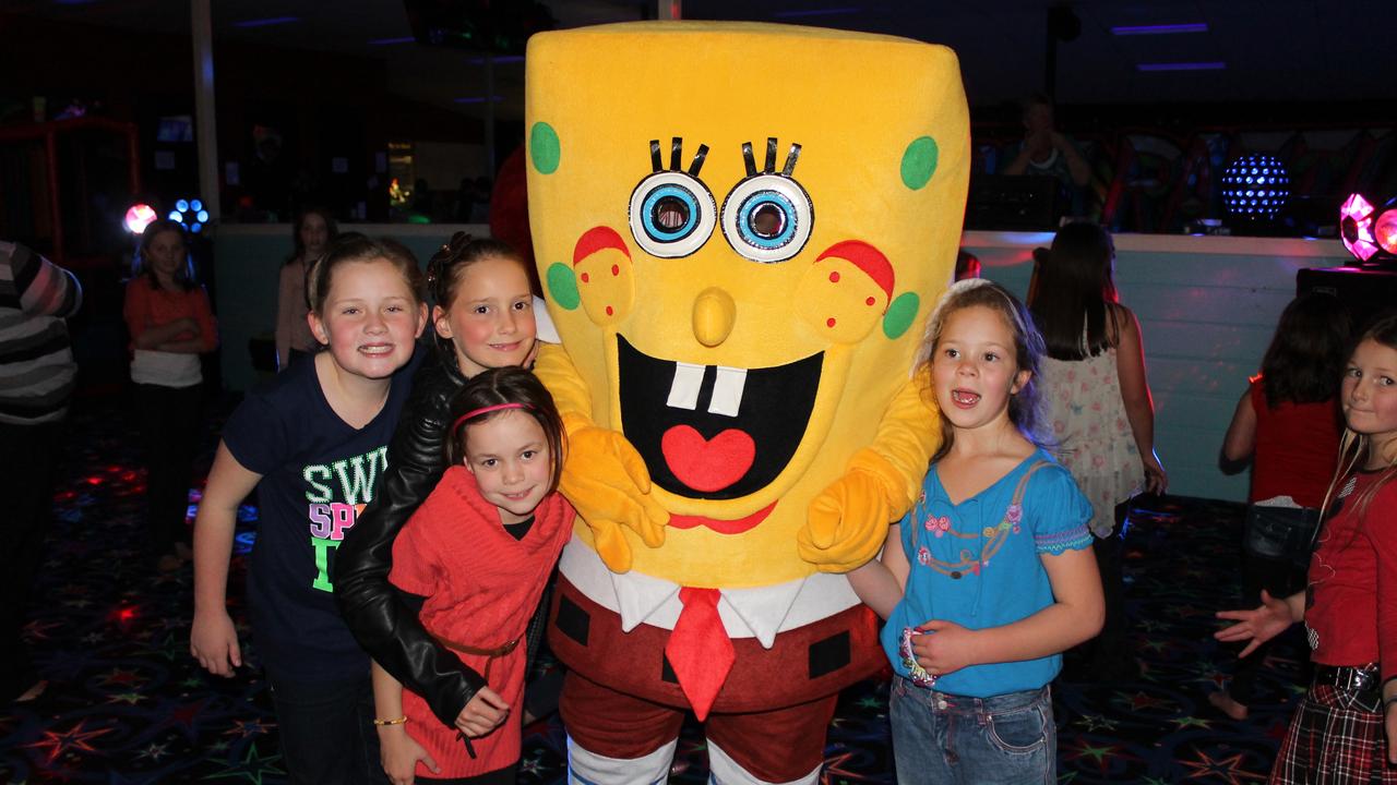 SPONGE BOB: Lara Beckett, Mia Swinburne, Tarryn Hines and Jasmine Clarke dance with Sponge Bob at the Blue Light Disco. Photo Linden Morris / Stanthorpe Border Post