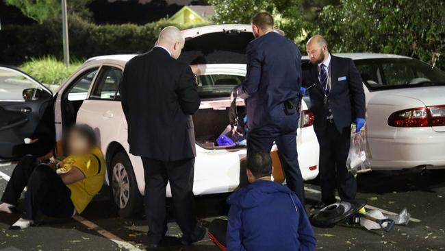 Detectives from Macquarie Fields search a car and make arrests in a drug bust last month.