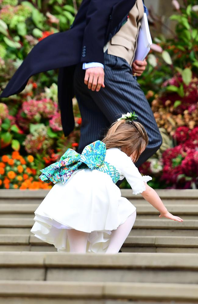 Princess Charlotte falls on the steps, as the bridesmaids and pageboys arrive for the wedding of Princess Eugenie. Picture: Getty