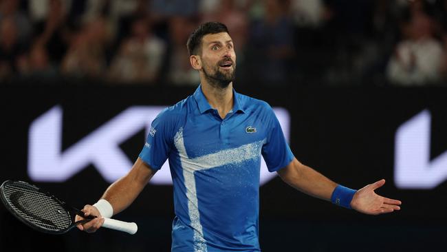 Serbia's Novak Djokovic gestures to the crowd after winning the third set during his men's singles quarterfinal match against Spain's Carlos Alcaraz on day ten of the Australian Open tennis tournament in Melbourne on January 21, 2025. (Photo by Adrian DENNIS / AFP) / -- IMAGE RESTRICTED TO EDITORIAL USE - STRICTLY NO COMMERCIAL USE --