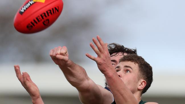 Ballarat’s Kyle Borg tries to prevent Hampden’s Hamish Cook from taking the mark. Picture Yuri Kouzmin