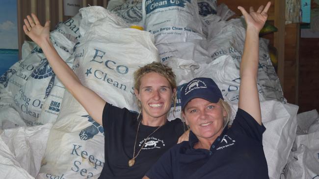 Eco Barge Clean Seas project coordinator Fiona Broadbent and Founding chairperson Libby Edge with some of the many bags of plastic bottles collected from Whitsunday beaches.