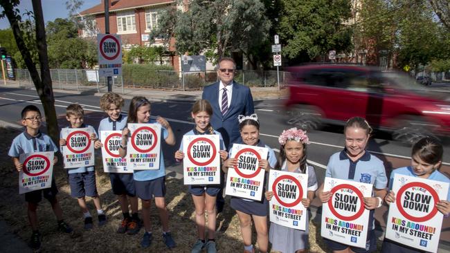 Ivanhoe Primary School Principal Mark Kent with some of the school’s Grade 4 students. They have put signs up outside the school warning drivers to slow down. Picture: Andy Brownbill