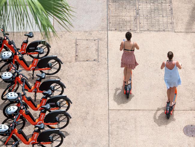 Two punters log on to their Neuron E-scooters at Darwin's Waterfront. Picture: Che Chorley