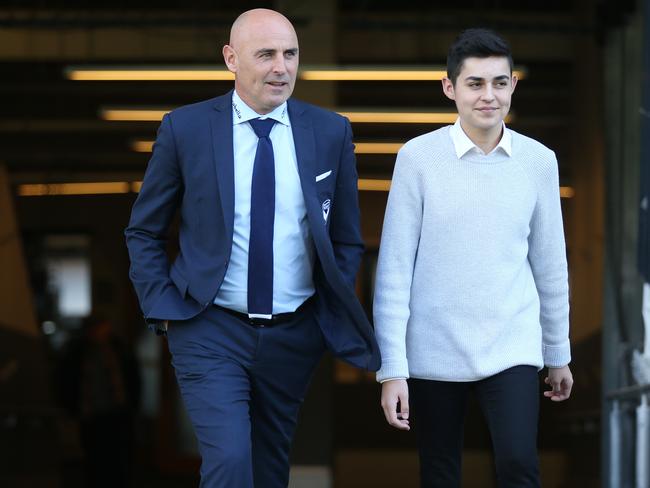 Melbourne Victory coach Kevin Muscat announcing that he is quitting the Victory after 14 years at the club.   Kevin and his son James walk up onto the AAMI Park pitch after todays press conference   . Pic: Michael Klein.