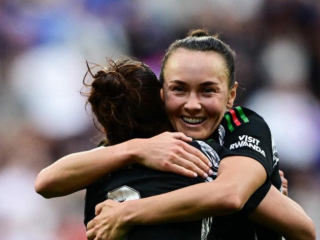 Arsenalâs Australian forward #19 Caitlin Foord (R) and Arsenalâs US defender #02 Emily Fox (C) embrace as they celebrate their victory at the end of the UEFA Women's Champions League semi-final second leg football match between Lyon and Arsenal at the Groupama Stadium in Decines-Charpieu, central-eastern France on April 27, 2025. (Photo by OLIVIER CHASSIGNOLE / AFP)