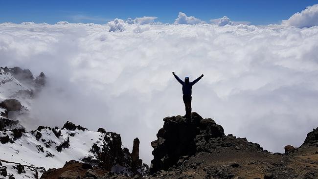 Climber Steve Plain on the crater rim at the top of Mount Kilimanjaro.