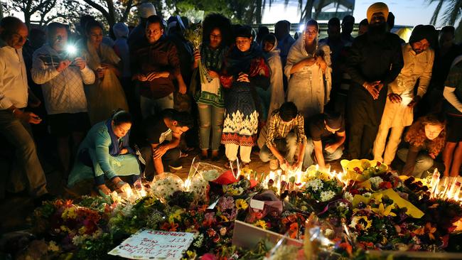 Mourners at the memorial Saturday night. Pic: Jack Tran