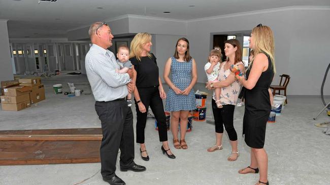 Michael (holding Connor Hain) and Suzi McEachern, Early Childhood teacher Alison Christian, mum Natalie Hain and Lucy and mum Jess and Zahlee Rozynski at the Moreton Drive Early Learning Centre. Picture: Tony Martin