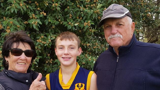 Fatal tribute - Roger Bates . Roger, Judith and grandson Jakob at SAPSASA football . Picture: Supplied by family