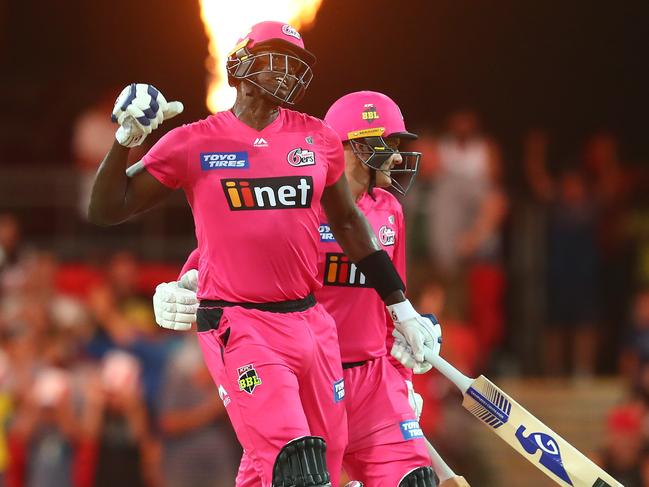 GOLD COAST, AUSTRALIA - DECEMBER 29: Jason Holder and Ben Manenti of the Sixers celebrate winning the Big Bash League match between the Melbourne Renegades and the Sydney Sixers at Metricon Stadium, on December 29, 2020, in Gold Coast, Australia. (Photo by Chris Hyde/Getty Images)