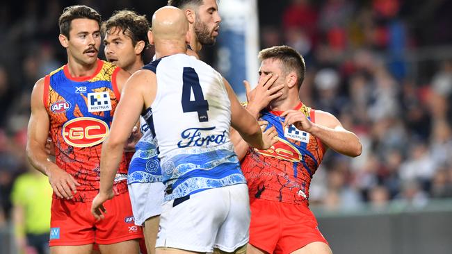 Miles grabs his face after being struck by Ablett.