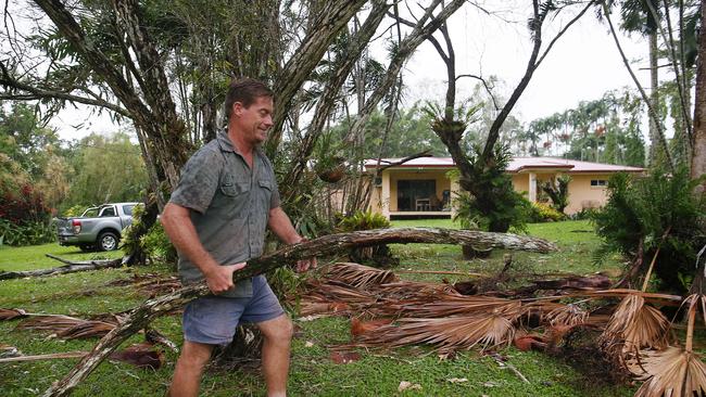 Jason Scott removes fallen tree branches from his sister's front yard in Edmonton. Picture: Brendan Radke