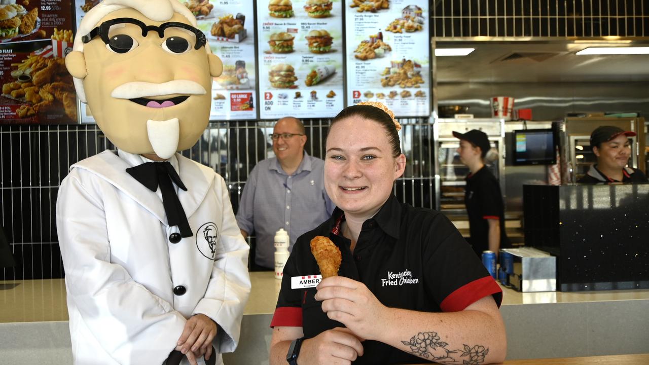 KFC mascot, Colonel Sanders, with store manager Amber Harding-Dolan and area manager Trent Brigginshaw.