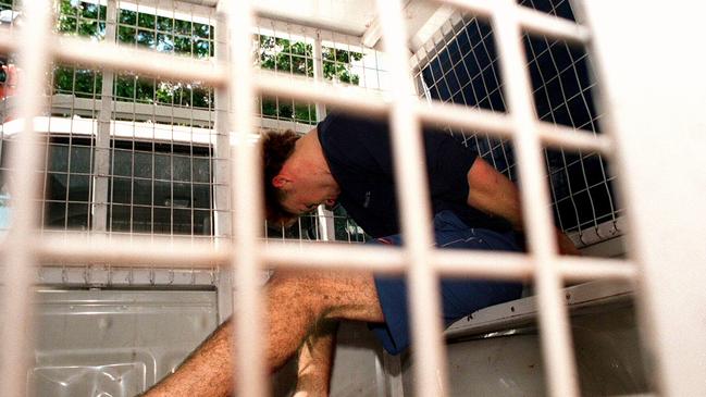 Berichon sitting in the back of police van after his capture in Darwin. 