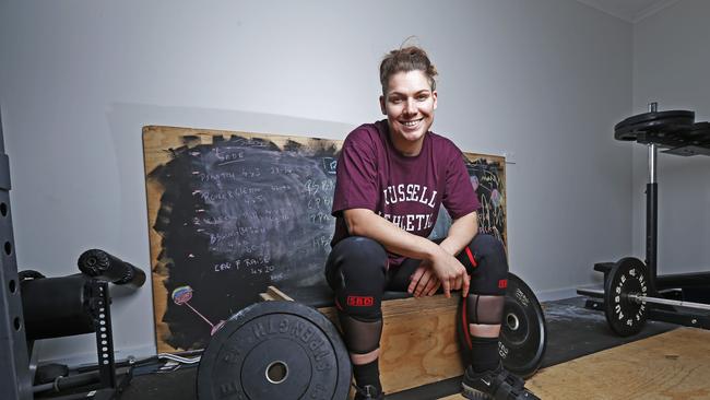 Weightlifter Kaity Fassina trains inside her Risdon Vale garage whilst in isolation ahead of the Tokyo Olympics next year. Picture: Zak Simmonds