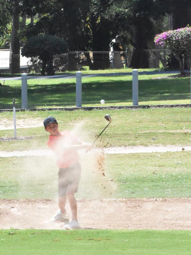 Keanu Faulks (boys 13-14 years) blasts out of the bunker during his round on the opening day of the US Kids Golf Foundation Australian Open at the Rockhampton Golf Club on September 27.