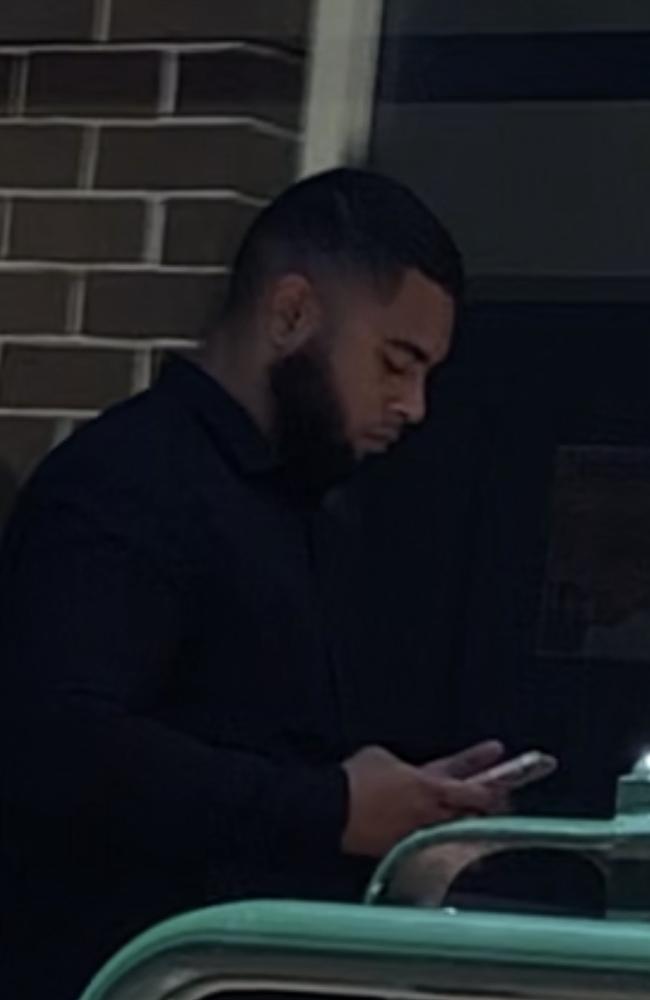 Joseph Toga, 23, of Campsie, on his phone outside Manly Local Court on January 25. Picture: Manly Daily