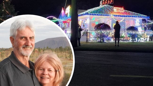 Geoff and Jenny Stolberg and one of the decorated houses in Gympie this year. Photo: Toni-Maree Gerhardt