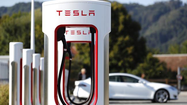 A Tesla Model S electric vehicle charging roadside. Viva and Ampol are rolling out roadside charging stations. Photographer: Stefan Wermuth/Bloomberg