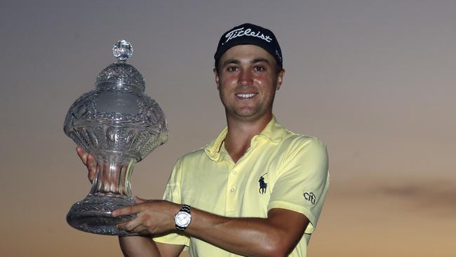 Justin Thomas holds up his trophy after winning the Honda Classic.