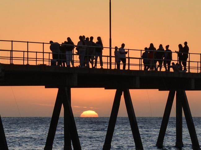 The last sunset for 2020 looking through Glenelg jetty, Thursday, December 31, 2020. Pic: Brenton Edwards