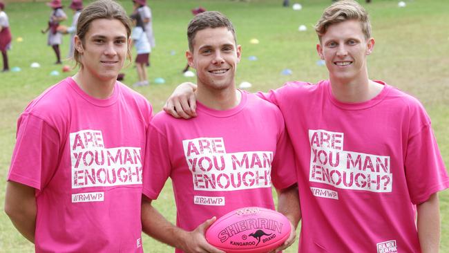 Jack Steele (left) had his own experience with breast cancer in his family and is putting weight behind the National Breast Cancer Foundation’s Real Men Wear Pink campaign. He is pictured with fellow midfielders Josh Kelly and Lachie Whitfield. Picture: Timothy Clapin.