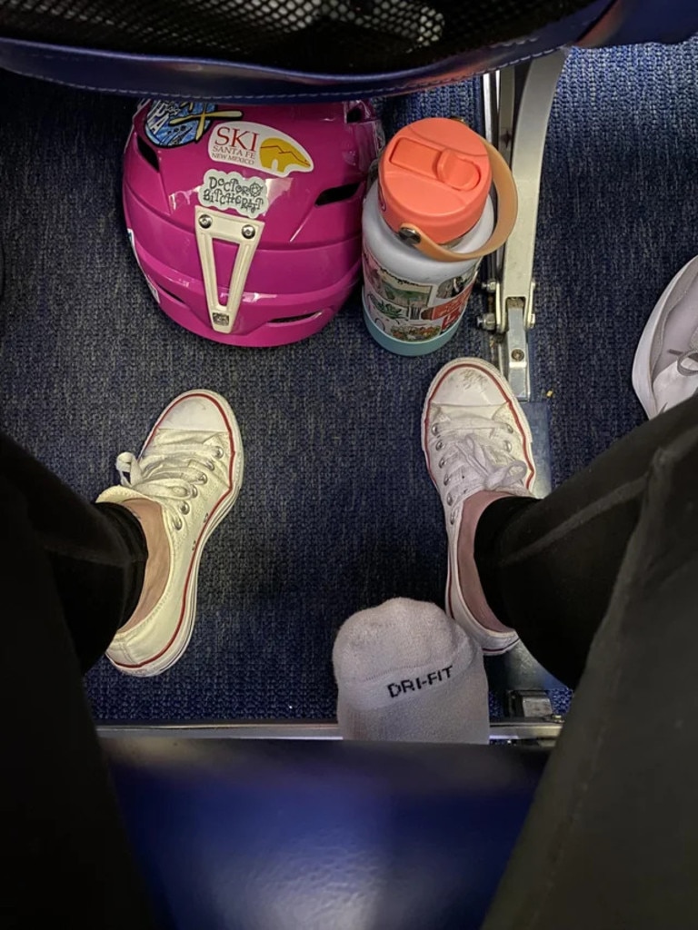 A passenger photographed the appalling moment when the flyer behind her poked their foot underneath their seat, as detailed in a viral Reddit post. Picture: Reddit/stefahnia