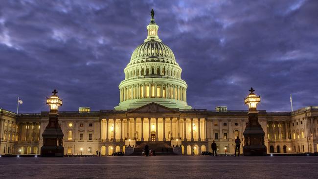 Lights shine inside the US Capitol Building as night falls in Washington. Picture: AP