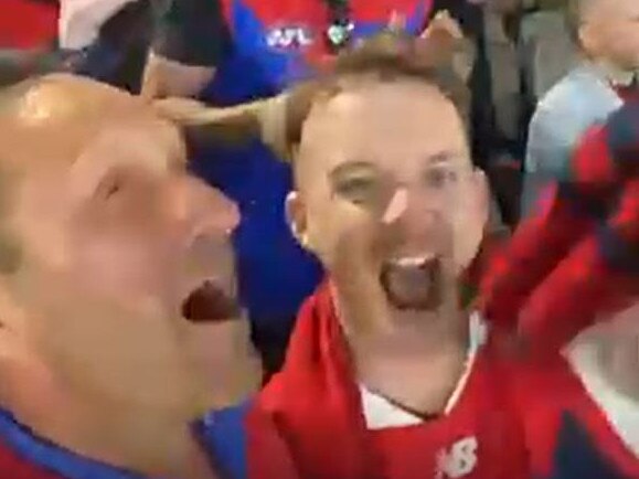 Hayden Burbank and Mark Babbage celebrating the Melbourne football club’s premiership.