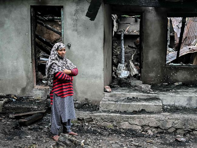 A woman stands outside a house destroyed by Pakistani artillery shelling at the Salamabad village in Uri. Picture: Sajjad Hussain / AFP