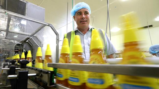 9/2/2017: Capilano CEO Ben McKee on the honey filling line, at their production plant in Richlands, Brisbane. Capilano is the biggest Australian honey label and processor,  now developing new manuka and prebiotic honeys - as well as natural  floral honeys - which are health products to export mainly to China. Lyndon Mechielsen/The Australian