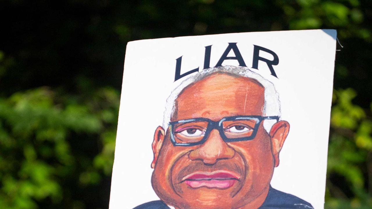 A demonstrator holds a sign during protests at the entrance of the gated community where US Supreme Court Justice Thomas Clarence lives. Picture: Roberto Schmidt/AFP