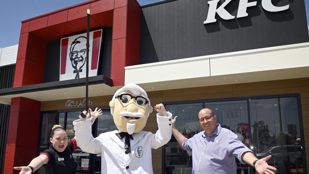 KFC opens in Highfields. KFC mascot, Colonel Sanders, with store manager Amber Harding-Dolan and area manager Trent Brigginshaw.