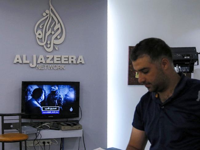 (FILES) An employee of the Qatar based news network and TV channel Al-Jazeera is seen at the channel's Jerusalem office on July 31, 2017. The Palestinian Authority on January 1, 2025 ordered the suspension of broadcasts by the Qatar-based Al Jazeera across the Palestinian territories, accusing the network of airing "inciting content," official media reported. (Photo by AHMAD GHARABLI / AFP)