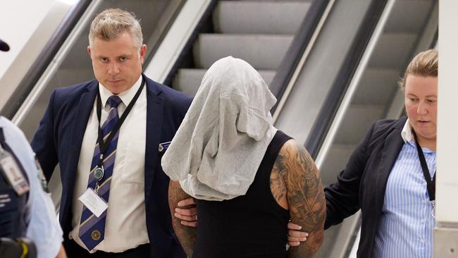 Detective Sergeant Kieran Glenzendorf and Detective Senior Constable Kristy McGee lead Pham through Sydney International Airport, following his arrested in April 2023. Picture: NSW Police