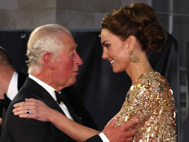 (FILES) Britain's Prince Charles, Prince of Wales (L) kisses Britain's Catherine, Duchess of Cambridge as they arrive for the World Premiere of the James Bond 007 film "No Time to Die" at the Royal Albert Hall in west London on September 28, 2021. Britain's King Charles III will attend hospital next week for a corrective procedure to treat an enlarged prostate, Buckingham Palace said on January 17, 2024. The statment was published on the same day of Kensington Palace's one announcing that Britain's Catherine, Princess of Wales is facing up to two weeks in hospital and several months' recuperation after undergoing successful abdominal surgery. (Photo by Chris Jackson / POOL / AFP)