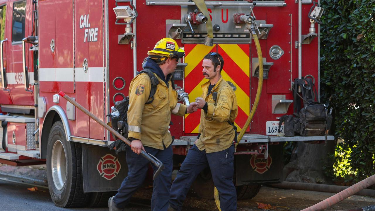 Firefighters work to extinguish the last embers in the hills of Mandeville Canyon after the Palisades Fire burned part of it. Picture: Valerie Macon/AFP