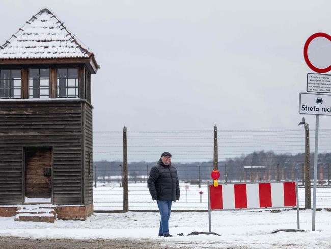 Andrzej Ryszka – mayor of Brzezinka stands next to the fence and the watchtower of the former Nazi camp Auschwitz 2 in Brzezinka, Oswiecim's neighbouring village. Picture: Wojtek Radwanski/AFP