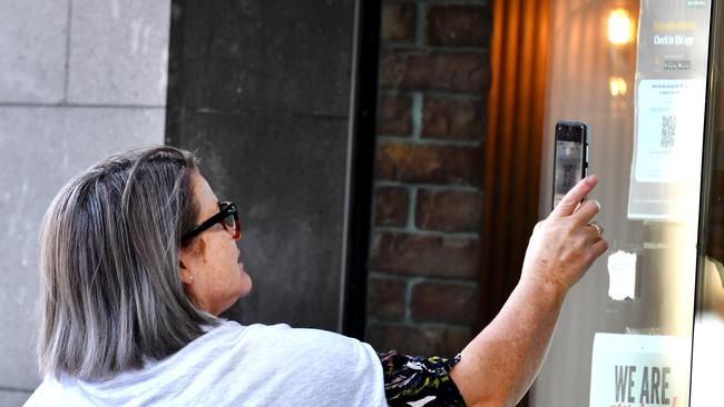 A person using the Check In Queensland app at South Bank in Brisbane. Picture: NCA NewsWire / John Gass